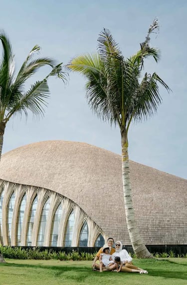 Family portrait in front of The Apurva Kempinski Bali chapel overlooking the Indian Ocean