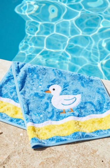 A collection of colorful soccer jerseys is laid out, each featuring distinctive team logos and color patterns. The jerseys include stripes, stars, and various shades, providing a rich visual contrast.