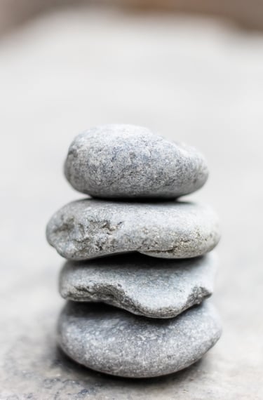 a balanced stack of light grey rocks