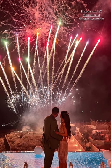 Vibrant fireworks display synchronized with music at a Santorini wedding party.