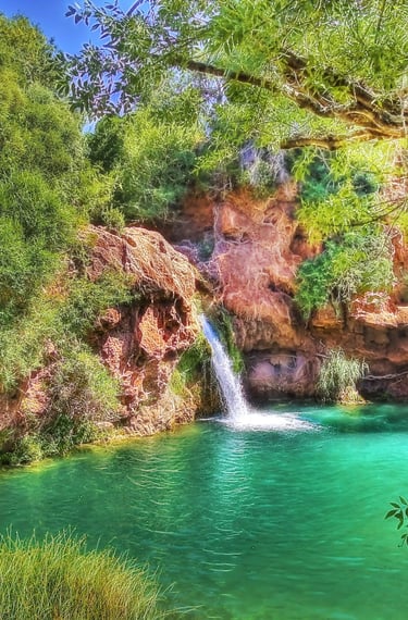 a waterfall in a canyon near a waterfall