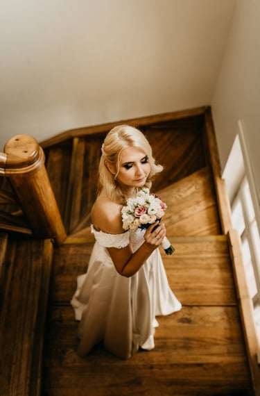 a bridesmaid in a white dress and a bouquet