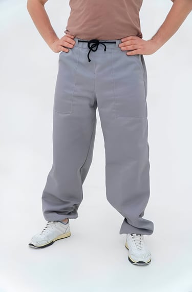a man in a brown shirt and grey bee pants