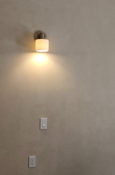 Modern wall sconce installed as part of a residential lighting project