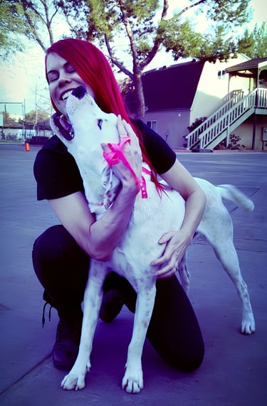 Rock of Love star and Heroes K9 Rescue founder, Lacey Sculls, hugging a rescued dog