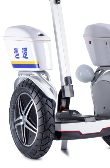 a white scooter with a white wheel and a black wheel