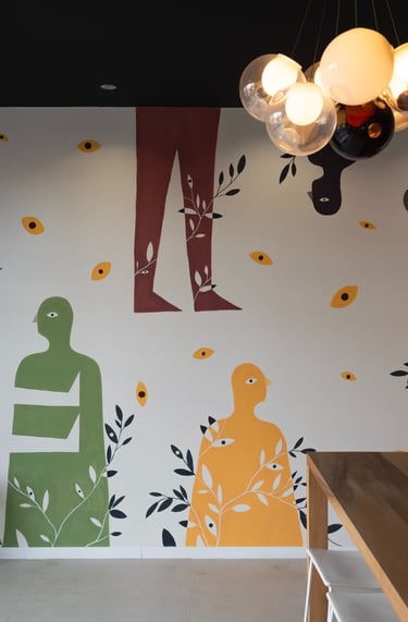 a wall mural of a woman sitting on a bench