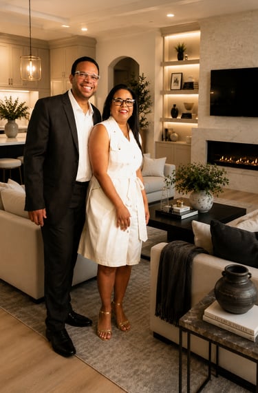 Alex and Karleen Asencio couple posing in a modern luxury living room with a fireplace.