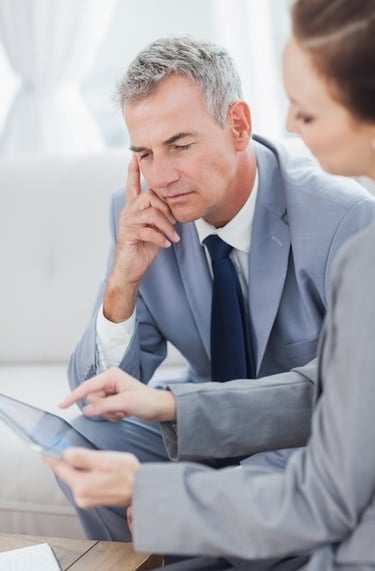 a business man and woman sitting at a desk