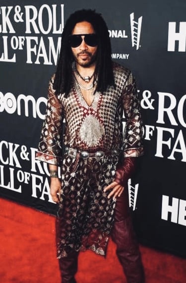 Musician Lenny Kravitz handsome in Assuit tunic boots and sunglasses