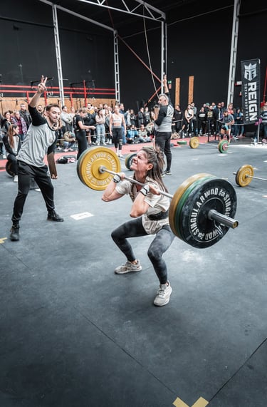 a woman is doing a squat - lift in a gym