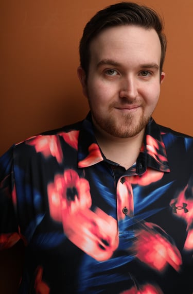 Cade MacFee actor headshot on a orange background