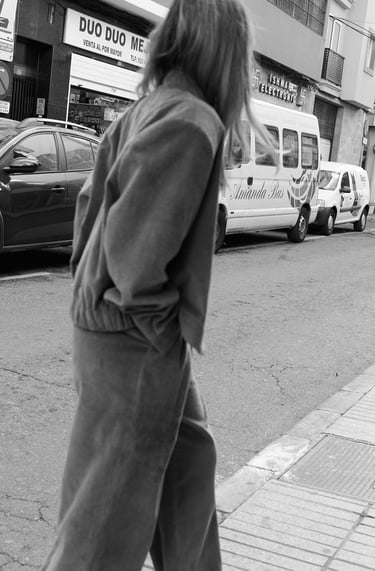 a woman walking down the street in a city