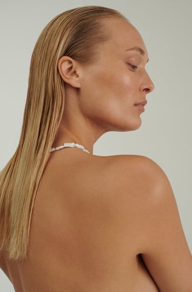 a woman with a white bra in a bikini top