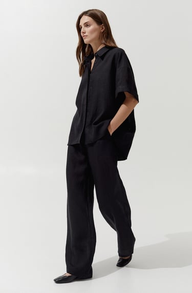 a woman in a black shirt and pants