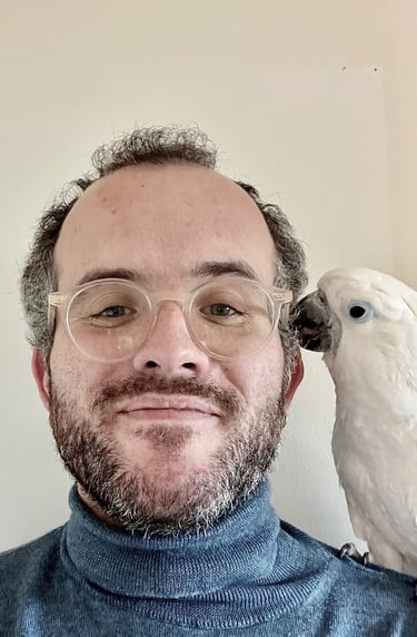 a man with glasses and a parrot on his head
