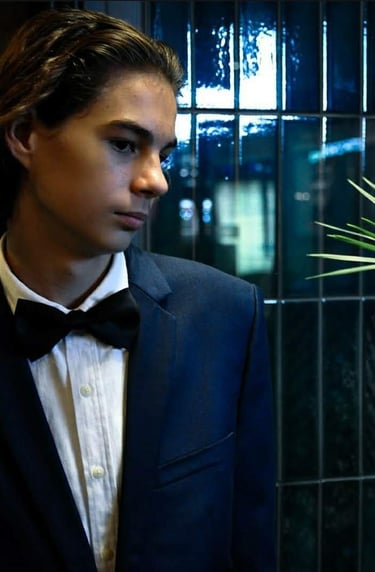 a man in a tuxedo suit and bow tie