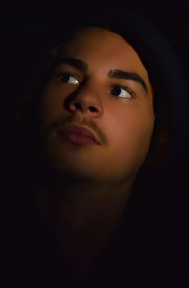 a man with a hoodie and and vigilante lighting