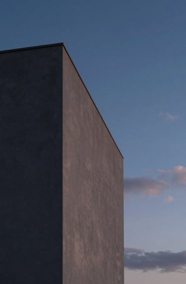 Twilight photography of a minimalist building exterior in Portugal. The structure glows softly against a deep blue sky. Refined Midnight Grey and Soft Cloud palette, elegant lighting, cinematic composition.