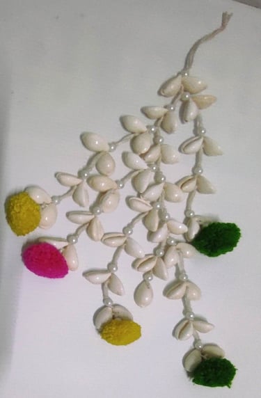 "Handmade shell hair tassel with colorful artificial flower ends–tribal-inspired accessory-Designed for export"