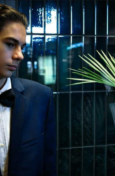 a man in a tuxedo suit and bow tie