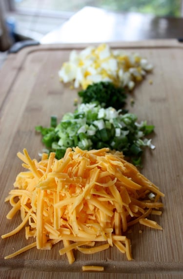 chopped and grated ingredients needed for stuffed potatoes