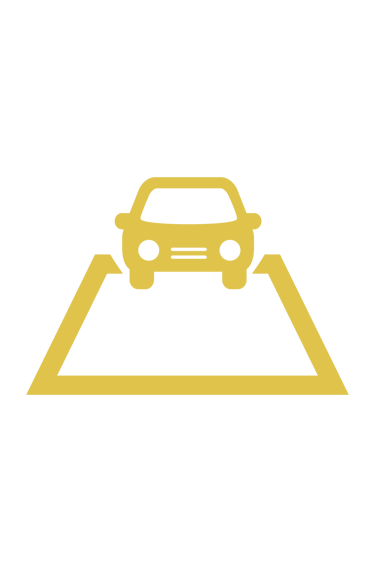 a car driving down a hill with a car in the background