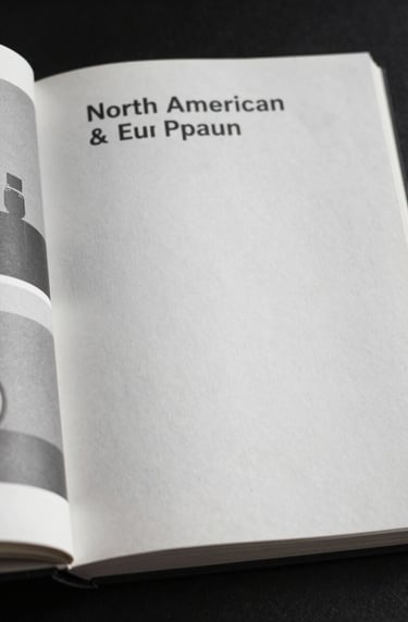 Close up shot of an open art publication featuring clean sans-serif typography and black and white imagery, North American / European studio, natural side lighting, emphasizing paper texture, soft gray and white tones.
