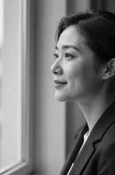 A professional black and white portrait of a person looking out a window with a peaceful expression, featuring high contrast and elegant composition. Touches of #1A2F3C and #F5F2EC in the grading. Evokes a sense of trust and deep narrative.
