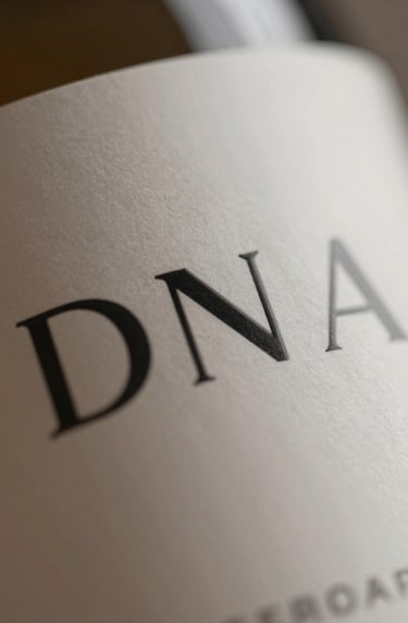 A detailed shot of typography on a curved packaging surface. The font is a crisp, modern sans-serif. Lighting highlights the premium ink finish and smooth surface. Sophisticated mood.