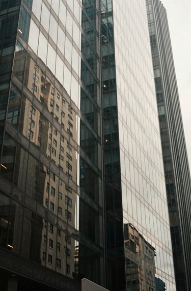 Detailed artistic shot of urban textures and glass reflections in a Latin American / Hispanic business district, sophisticated lighting with Soft Off-White highlights.