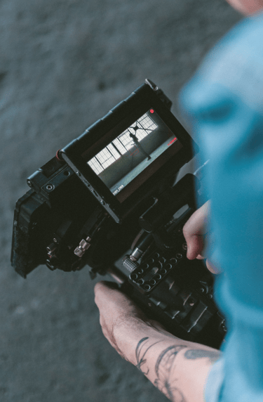 a person holding a camera and a cell phone