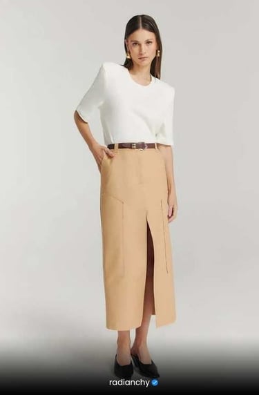 a woman in a white shirt and skirt with a skirt