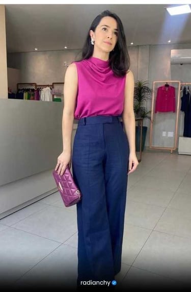 a woman in a pink top and blue pants