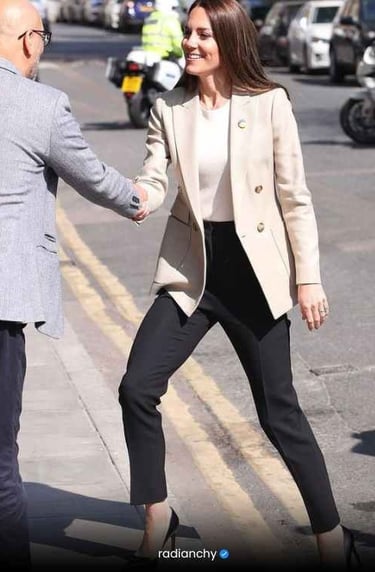 a woman in a white jacket and black pants