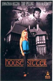 a woman standing in front of a house with a man in a blue shirt