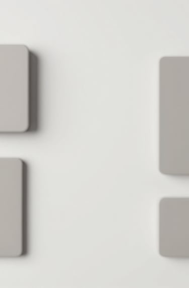 Lifestyle flat lay of high-end accessories. Minimalist composition with lots of white space. Muted tones of #D8D8D8 and #F8F5F2. High-end agency style.