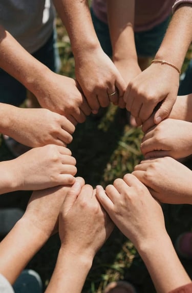 A detailed lifestyle shot of a family's hands joined together in a circle. Authentic skin tones, North American / US setting, sun-drenched cinematic lighting, warm atmosphere.