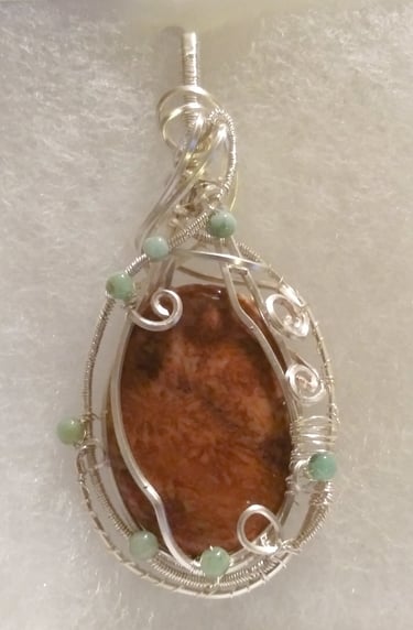 silver wire wrapped orange fossilized coral