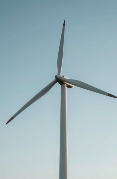 A low-angle shot of a wind turbine blade against a clear sky, representing energy transition and sustainable progress. The composition is minimalistic and authoritative, using #F5F8FA and #4A6D7C in the lighting and atmosphere.