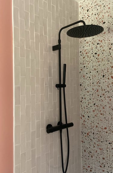 a shower with a shower head and a shower head