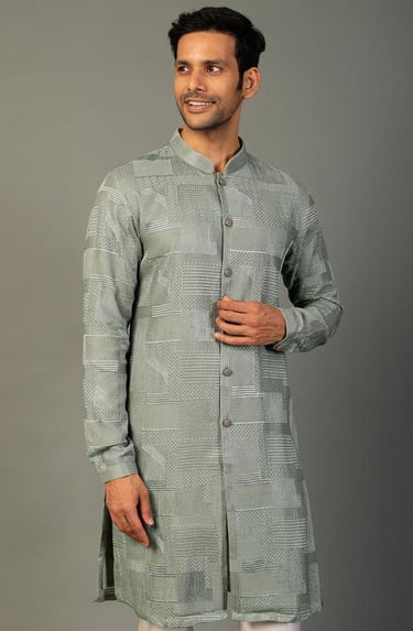 a man in a grey and white striped kurti kurti kurti kurti