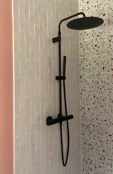 a shower with a shower head and a shower head