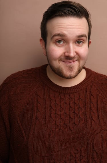 Cade MacFee actor headshot on a blush background