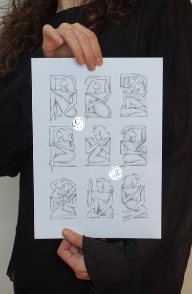 Minimalist pencil sketches of female figures in geometric poses on white paper held by an artist.