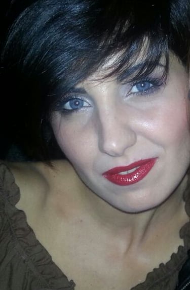 a woman with a red lipstick and a black jacket