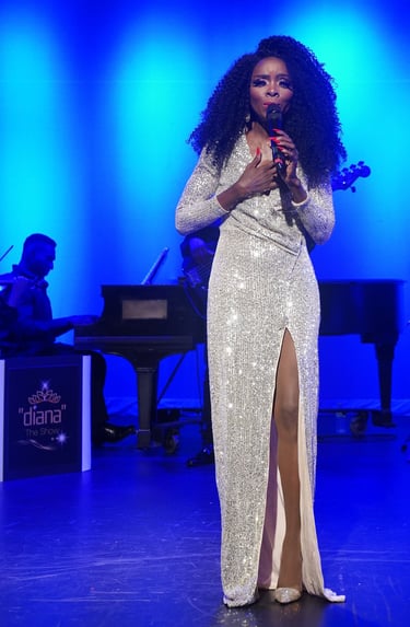 a woman in a white dress standing in front of a microphone