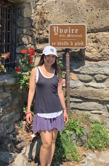 a woman standing in front of a sign