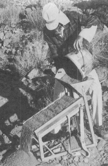 a man in a mining outfit holding mining equipment