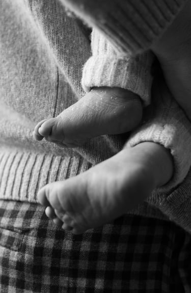 black and white image of newborn's feet